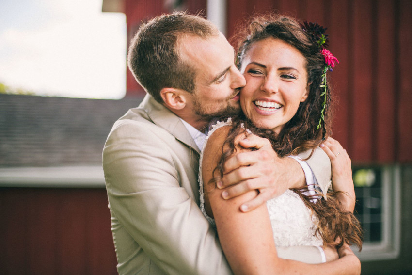 064 Mukwonago Milwaukee WI Barn DIY Laid-back Close up of Bride Groom Portrait Kissing Cheeks Danny Andrea