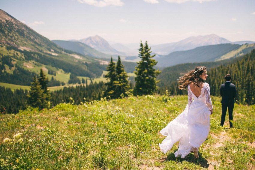 bride walking toward groom first look crested butte washington gulch