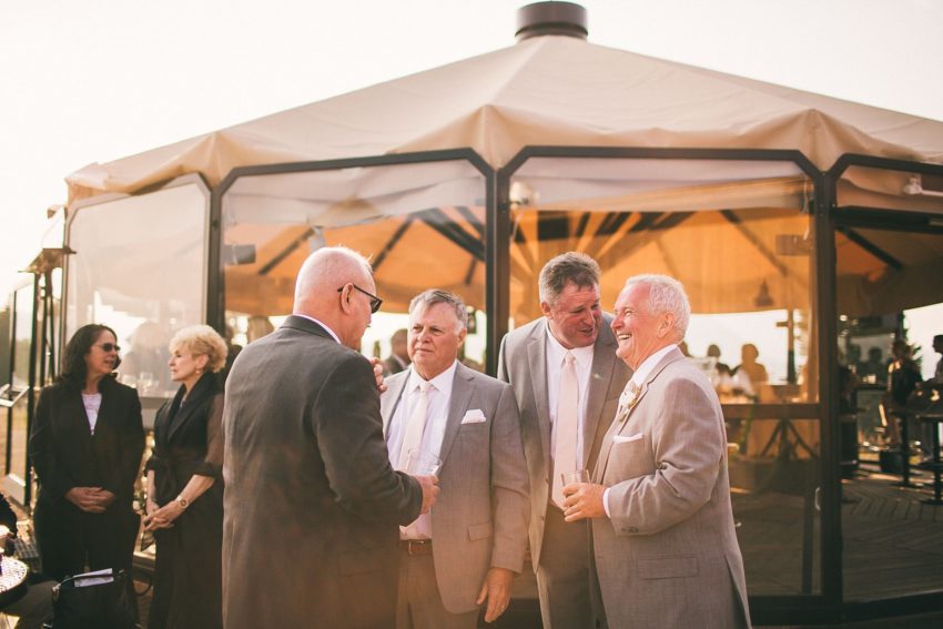 Guest Mingling Umbrella Bar Crested Butte on Wedding Day Cocktail Hour