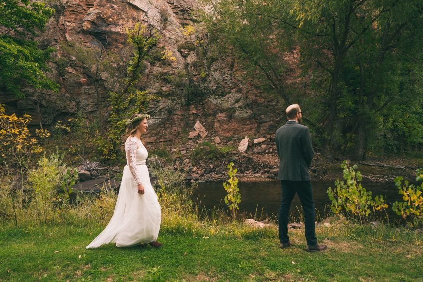 Bride and groom's first look on wedding day Rock face river Bend lyons Colorado