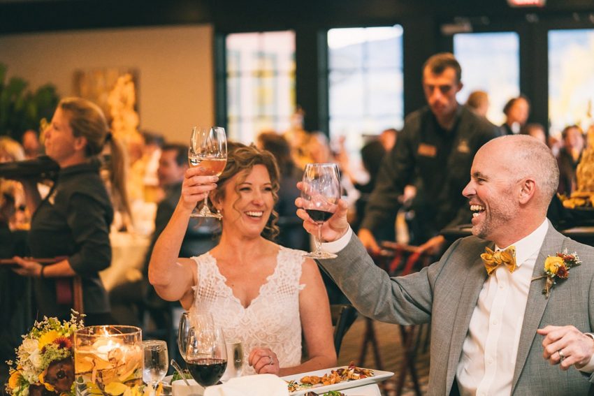 bride and groom enjoying wedding reception toasts
