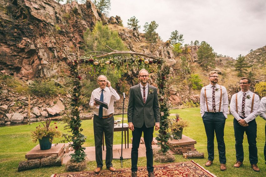 Groom waits for bride down the aisle