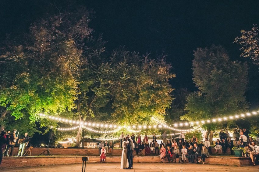 Wedding groom enjoying your first dance at River bend Lyons Colorado Under the bistro lights